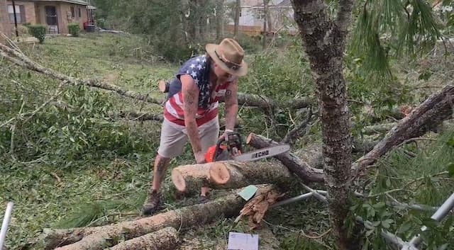 Storm Chaser Rob McBay works on removing a downed tree in the aftermath of Hurricane Isaias in Northwest Florida on Oct. 10, 2026. (Courtesy of Rob McBay)