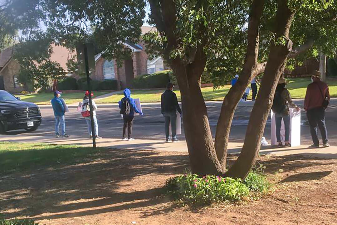 Protesters stand outside the home of Pastor Bob Fu in Midland, Texas, in fall 2020. Fu, whose organization, ChinaAid, advocates for religious freedom in China, has endured for years harassment campaigns including large crowds arriving at his home by bus in actions that he believes were coordinated by the Chinese government. (Bob Fu via AP)