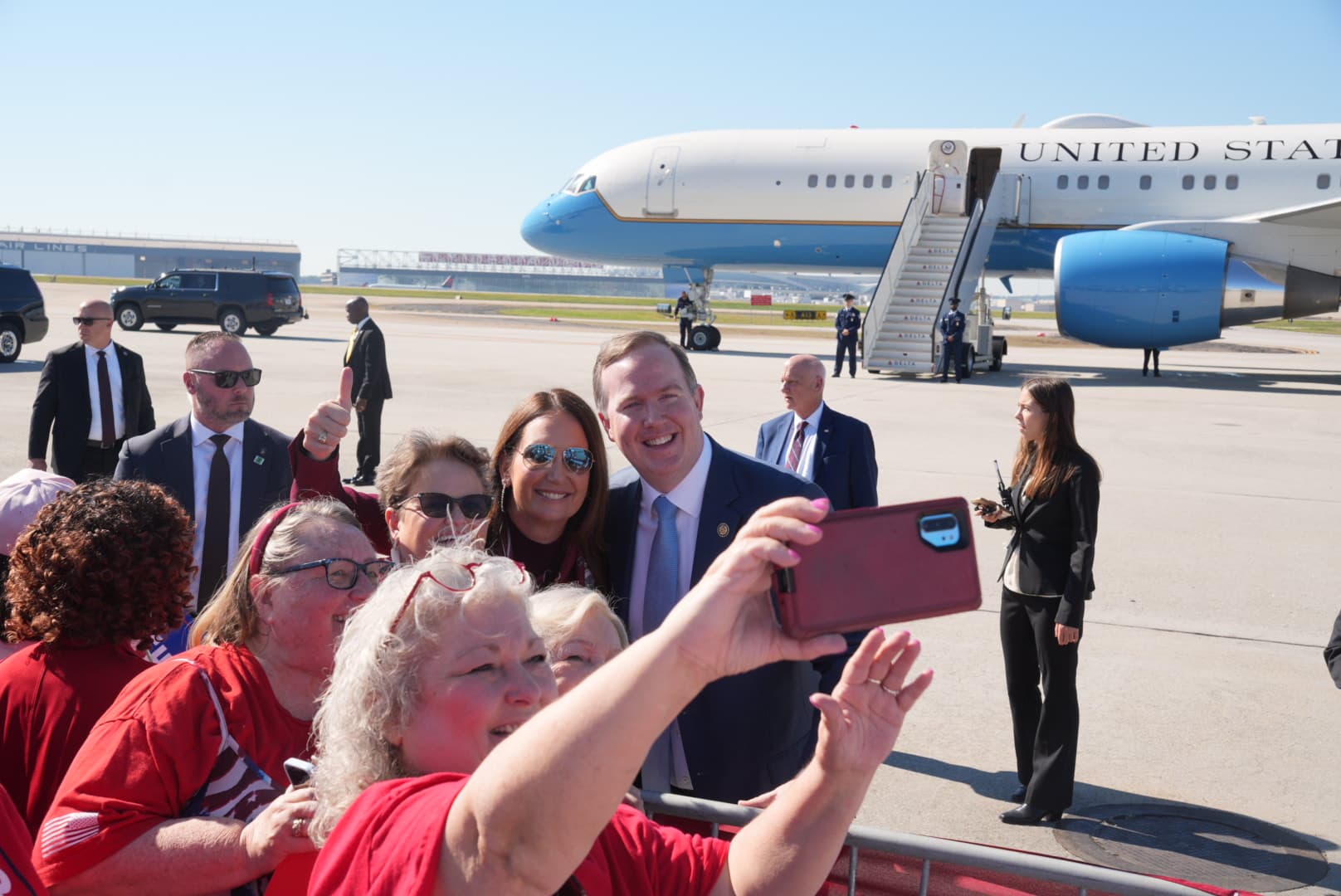 Agriculture Secretary Brooke Rollins poses with Rep. Brian Jack (R-Ga.) to take selfies with supporters in Atlanta, Ga., on Oct. 14, 2026. (Troy Myers/The Epoch Times)