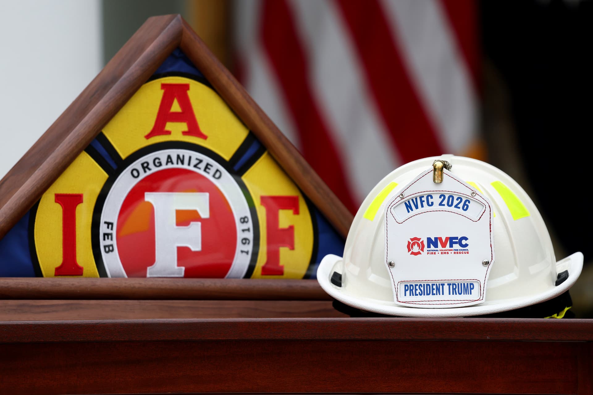 An International Association of Fire Fighters flag and National Volunteer Fire Council helmet are displayed ahead of a luncheon in the Rose Garden of the White House on Oct. 15, 2026. President Trump held the luncheon to honor first responders from across the country. (Kevin Dietsch/Getty Images)