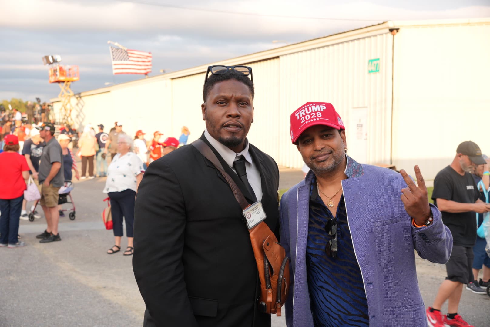Andy Acharya (R) poses with a friend after President Donald Trump finished a rally. The president went to boost voters in Dalton, Ga., on Oct. 16, 2026. (Troy Myers/The Epoch Times)