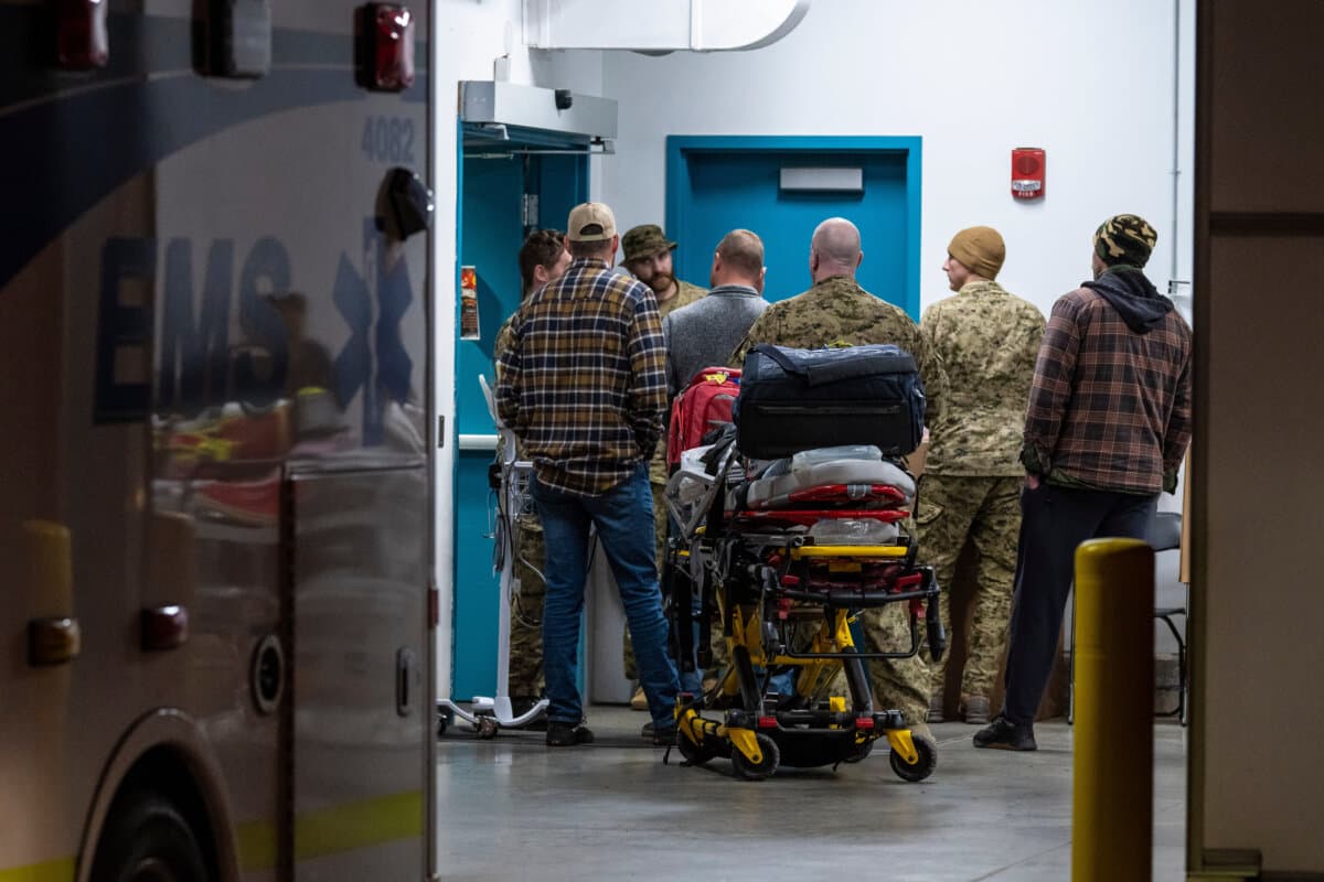 Emergency crews and military personnel are seen at the Wainwright Health Centre as injured military members are treated after a fire at Canadian Forces Base Wainwright outside of Wainwright, Alberta, on Oct. 17, 2026. (John Ulan/The Canadian Press via AP)