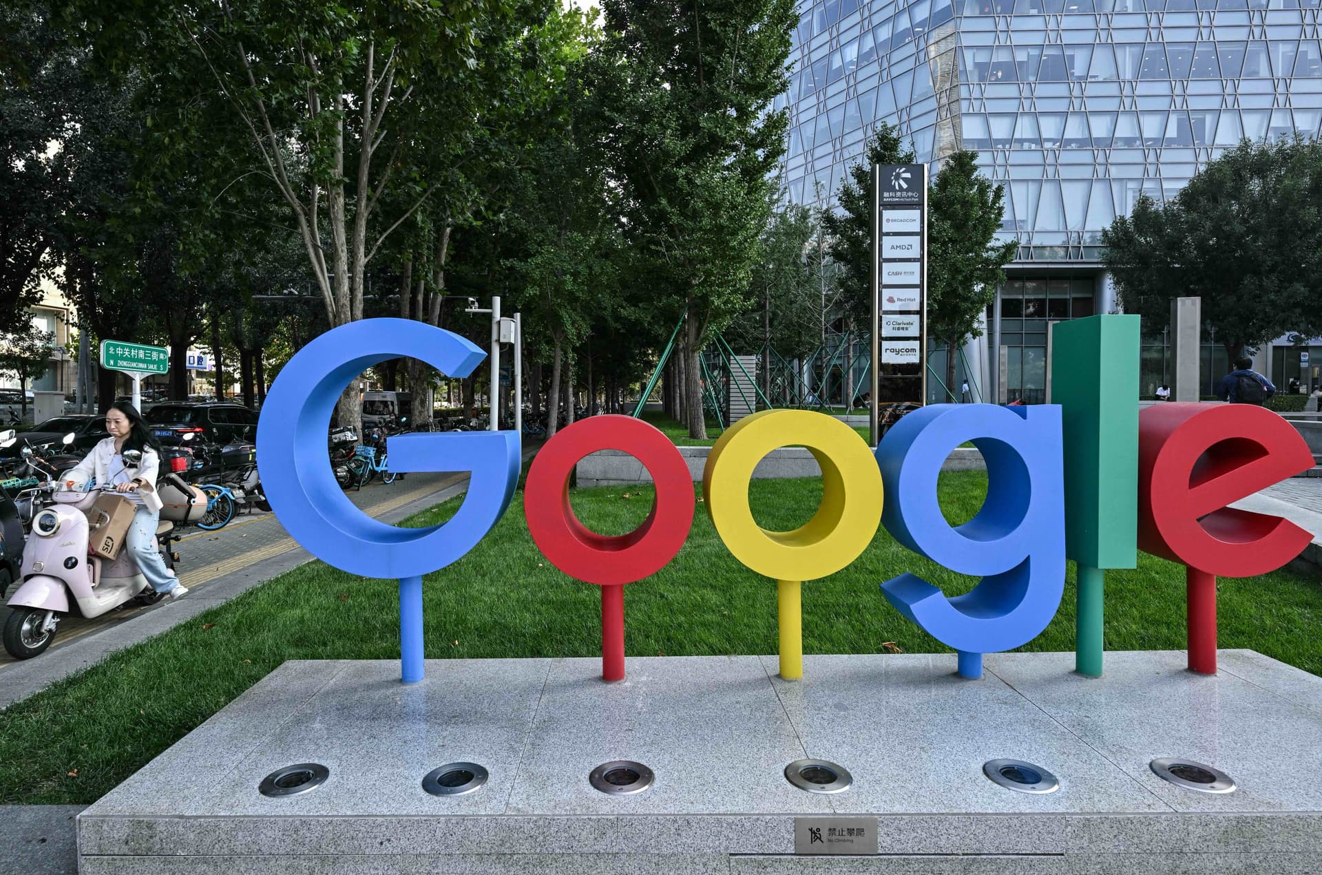 A motorist rides next to the logo of the Google company in Beijing on Sept. 22, 2026. (Adek Berry/AFP via Getty Images)
