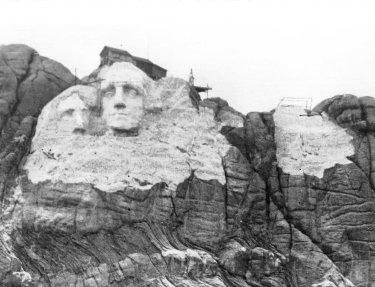 Construction underway, with Jefferson leftmost, before unstable rock necessitated a design change. (Public Domain)