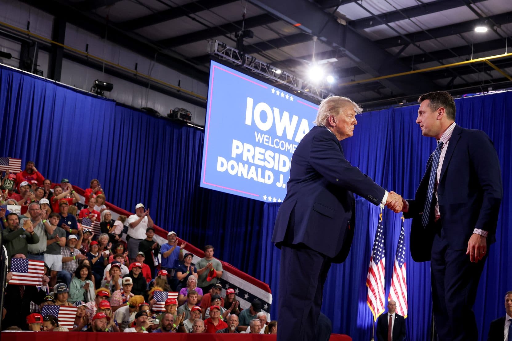 Iowa gubernatorial candidate Zach Lahn shakes hands with U.S. President Donald Trump after being invited on stage to speak at a rally at Sioux Gateway Airport on Oct. 22, 2026. (Anna Moneymaker/Getty Images)