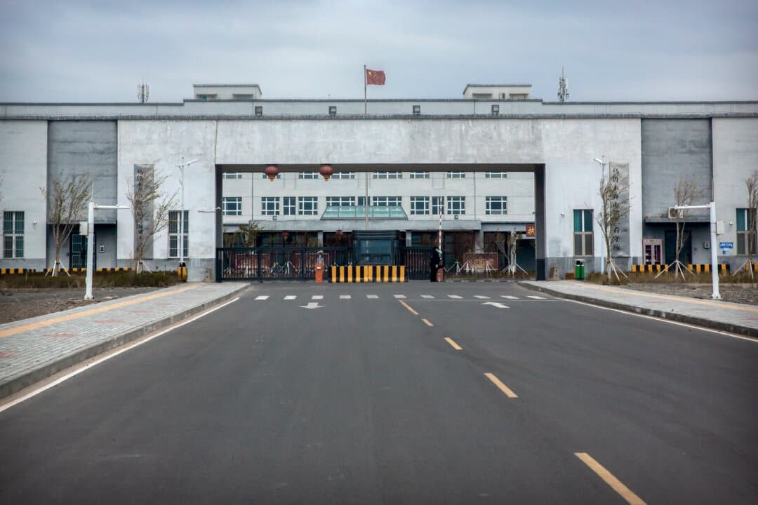 Police officers stand at the outer entrance of the Urumqi No. 3 Detention Center in western China's Xinjiang region on April 23, 2021. Urumqi No. 3, China's largest detention center, has room for at least 10,000 inmates. (Mark Schiefelbein/AP Photo/File)