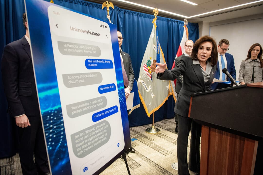 U.S. Attorney Jeanine Pirro points to a scam text message as she announces a strike force to go after crypto investment fraudsters in Washington on Nov. 12, 2025. (Cliff Owen/AP)