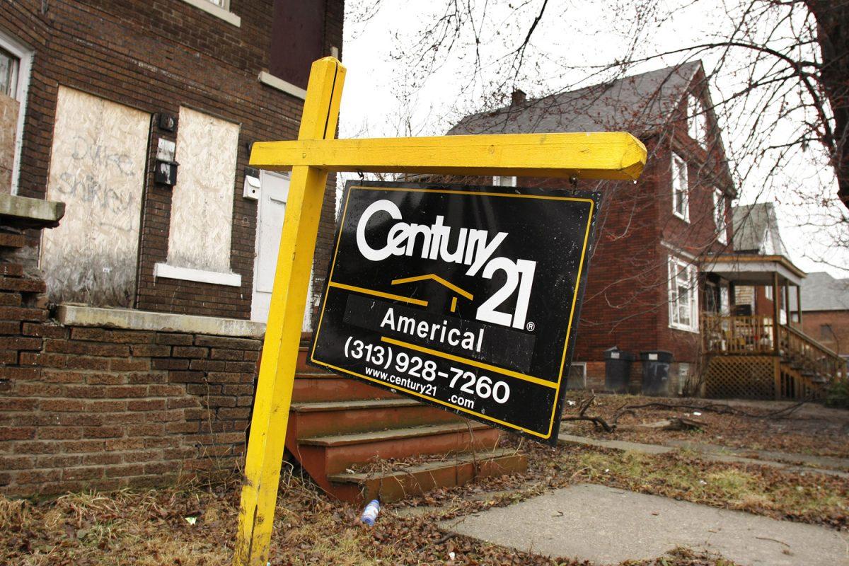 A realtor's sign sits in front of a boarded up house next to an occupied home in a Detroit neighborhood on March 23, 2011. (Bill Pugliano/Getty Images)