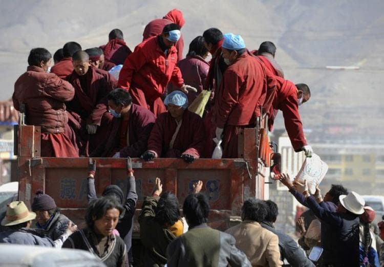 Tibetan Buddhist monks distribute relief goods from a truck after an earthquake in Jiegu, Yushu County, in China's northwestern Qinghai Province, on April 19, 2010. (Getty Images)