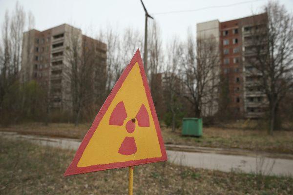 A sign warns of radiation contamination near former apartment buildings in Pripyat, near Chernobyl, Ukraine, on April 9, 2016. (Sean Gallup/Getty Images)