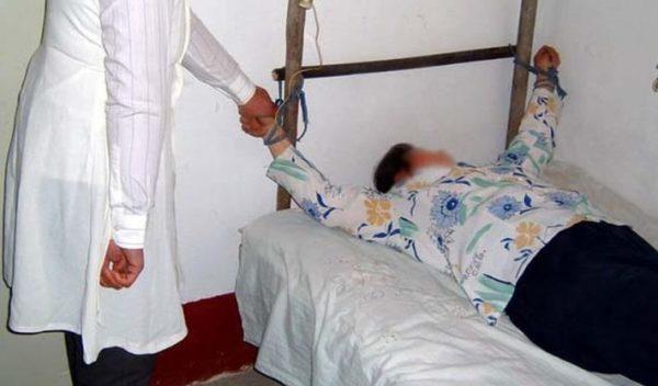 Torture re-enactment: Unknown drugs being forcibly injected into a Falun Gong practitioner to coerce them to renounce their faith. (Courtesy of Minghui.org)