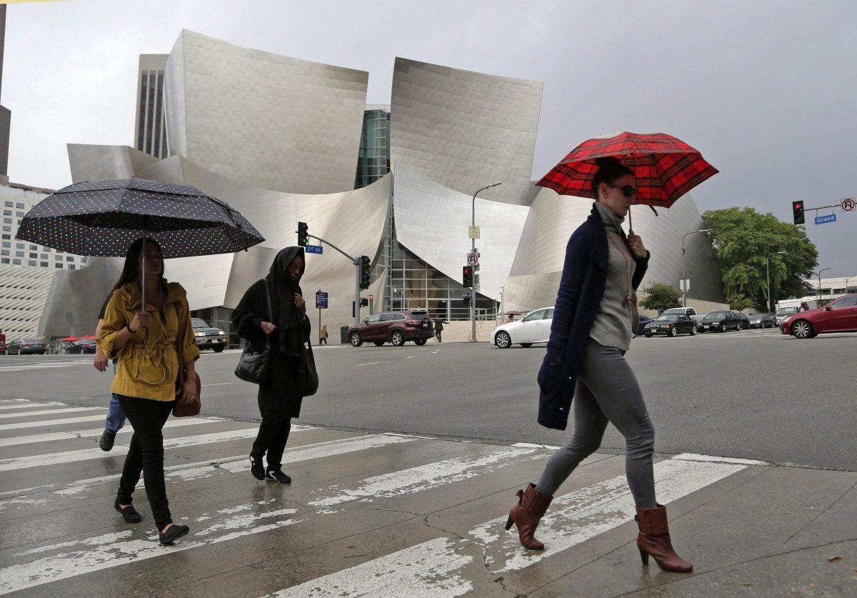 Workers cross the street near Disney Hall in downtown Los Angeles on Oct. 28, 2016. (Nick Ut/AP Photo)