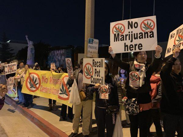 People holding signs protested outside the city hall in El Monte, California on Dec. 19, 2018. (Jenny Liu/The Epoch Times)