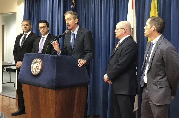 Los Angeles City Attorney Mike Feuer, at podium, speaks at a news conference in Los Angeles, on Jan. 4, 2019. (Brian Melley/Associated Press)