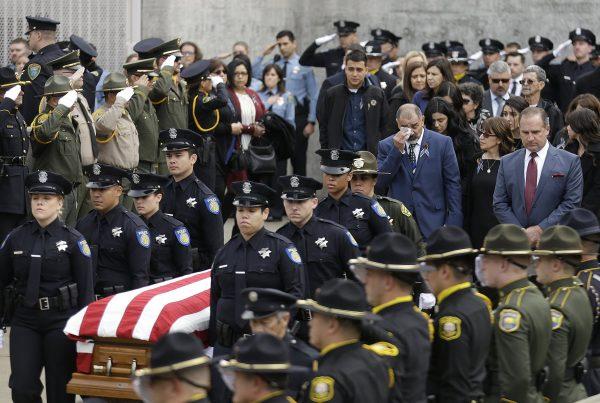 Family members follow the flag draped coffin of Davis Police Officer Natalie Corona before funeral services for Corona at the University of California, Davis, in Davis, Calif., on Jan. 18, 2019. (Rich Pedroncelli/AP)