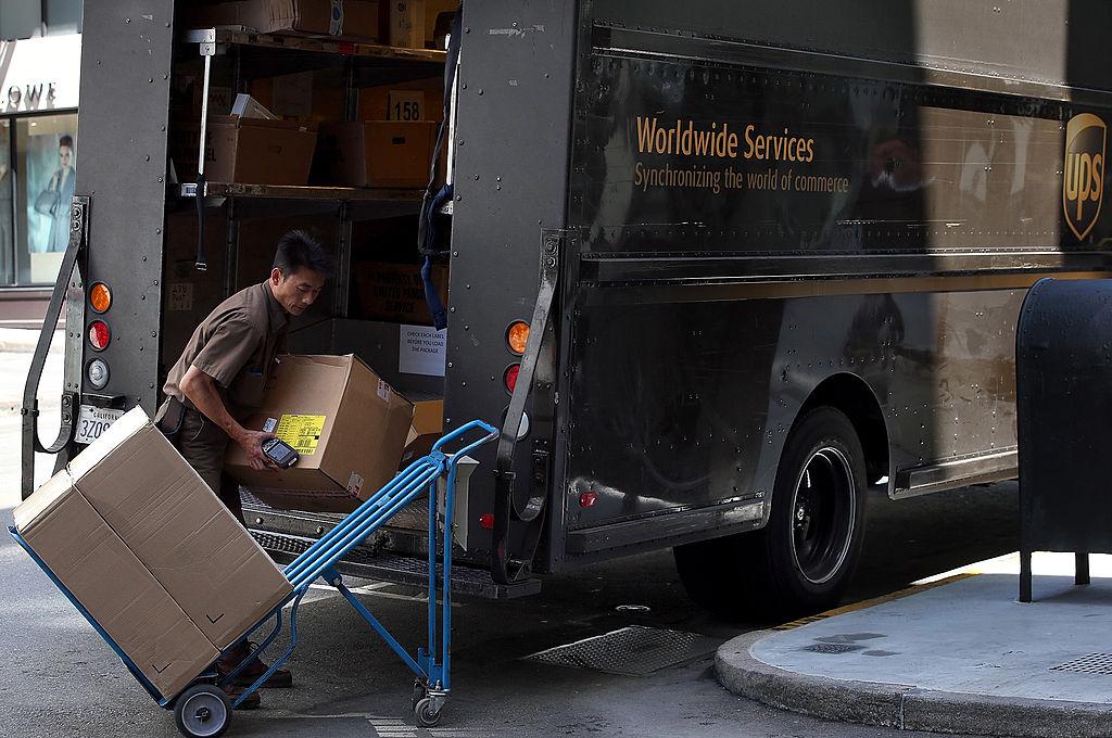 A United Parcel Service (UPS) driver loads a cart with boxes before making a delivery in San Francisco on June 17, 2014. (Justin Sullivan/Getty Images)