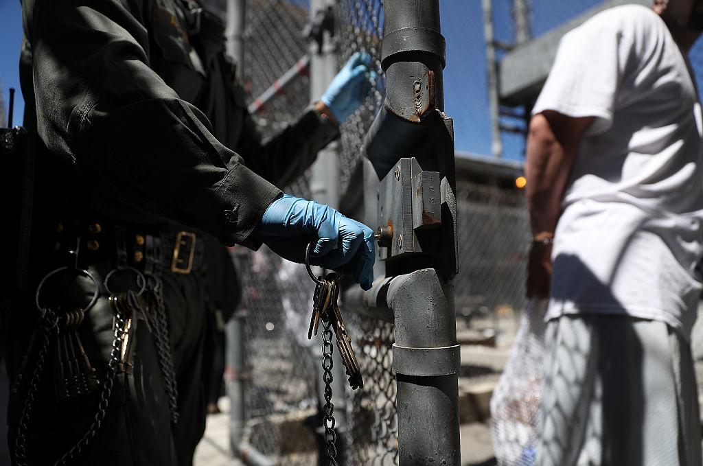 A California Department of Corrections and Rehabilitation officer opens the gate for an inmate who is leaving the exercise yard at San Quentin State Prison in San Quentin, Calif., on Aug. 15, 2016. (Justin Sullivan/Getty Images)