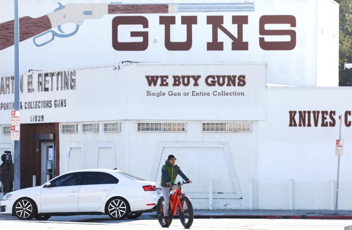 A cyclist rides past the Martin B. Retting Inc. gun store in Culver City, Calif., on March 24, 2020. (Mario Tama/Getty Images)