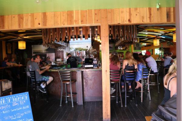 Customers relax along the bar at Nomads Canteen in San Clemente, Calif., on May 7, 2020. (Jamie Joseph/The Epoch Times)