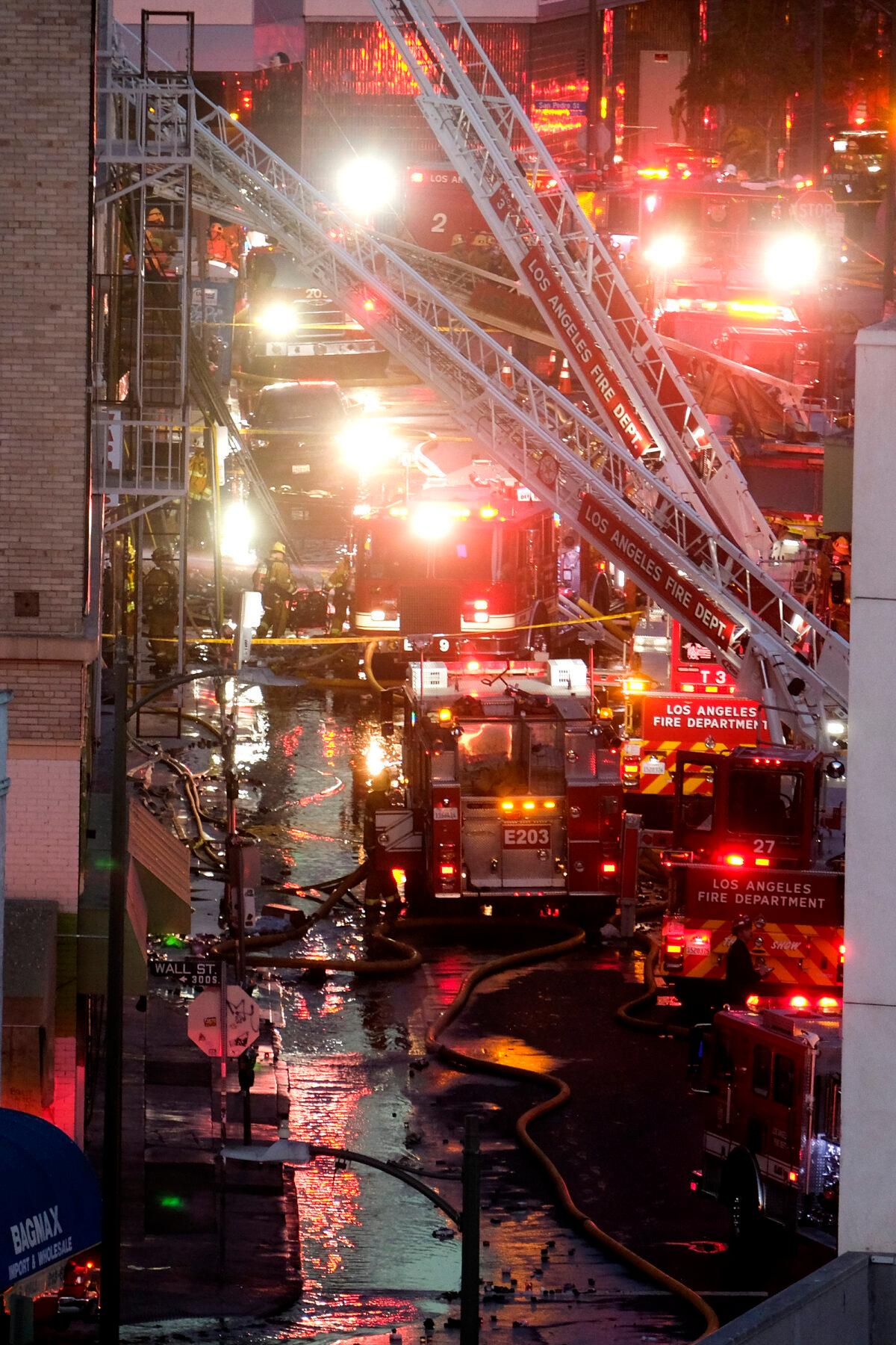 Los Angeles Fire Department firefighters work the scene of a structure fire that injured multiple firefighters, according to a fire department spokesman, in Los Angeles, Calif., on May 16, 2020. (Ringo H.W. Chiu/AP Photo)