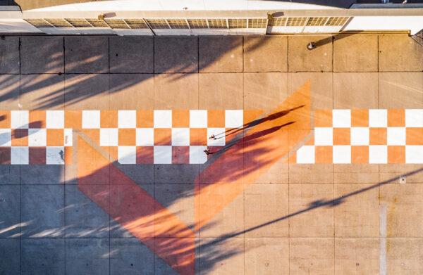 People walk past a closed aircraft hangar containing a vintage World War I plane at Orange County Great Park in Irvine, Calif., on July 2, 2020. (John Fredricks/The Epoch Times)