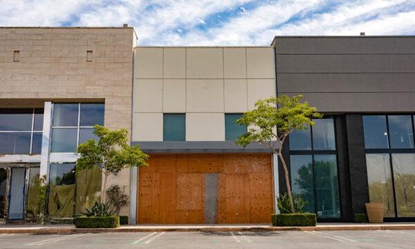 Retail space once belonging to a clothing store now sits boarded up in El Segundo, in Los Angeles County, Calif., on June 25, 2020. (John Fredricks/The Epoch Times)