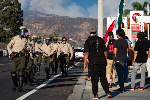Police control a protest in support of Black Lives Matter in Yucaipa, Calif., on Aug. 1, 2020. (John Fredricks/The Epoch Times)