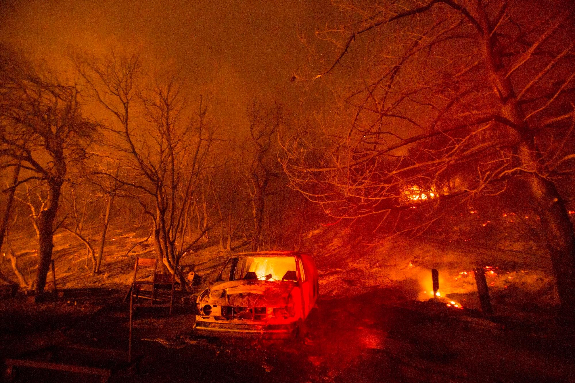 A burned vehicle is seen in the Lake Hughes Fire in Angeles National Forest in north of Santa Clarita, Calif., on Aug. 13, 2020. (Ringo H.W. Chiu/AP Photo)
