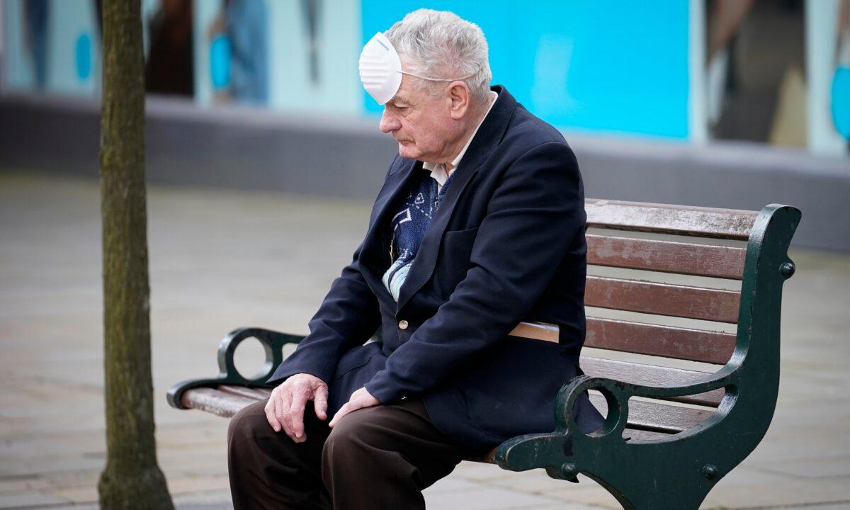 A man rests on a bench during the COVID-19 pandemic, in Oldham, England, on July 29, 2020. (Christopher Furlong/Getty Images)