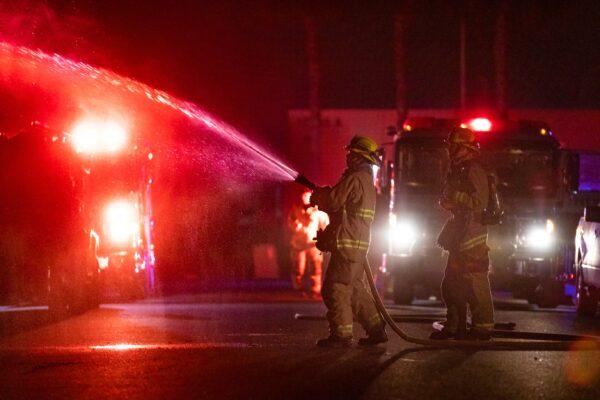 A firefighter puts out a fire in an electrical box in Fountain Valley, Calif., on Sept. 4, 2020. (John Fredricks/The Epoch Times)
