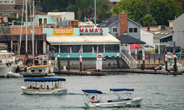 Boats travel in front of Mama's restaurant in Newport Beach, Calif., on Sept. 8, 2020. (John Fredricks/The Epoch Times)
