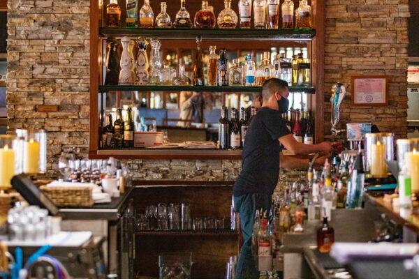 A restaurant worker prepares a beverage at Tavern House Kitchen and Bar in Newport Beach, Calif., on Sept. 9, 2020. (John Fredricks/The Epoch Times)