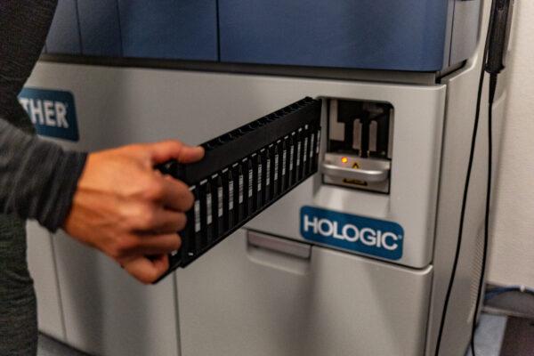 A sample chamber is inserted into a machine at EqualTox Laboratory with the ability to produce hundreds of COVID-19 test results in less than 24-hours, in Tustin, Calif., on Sept. 3, 2020. (John Fredricks/The Epoch Times)
