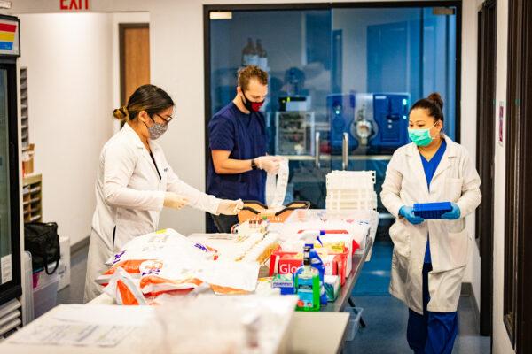 EqualTox lab workers process COVID-19 tests in Tustin, Calif., on Sept. 3, 2020. (John Fredricks/The Epoch Times)
