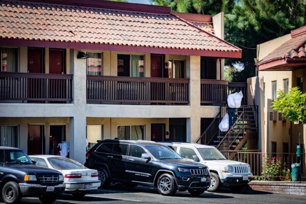 A housekeeper prepares to clean a room at the Red Roof Inn motel in Santa Ana, Calif., on Oct. 12, 2020. (John Fredricks/The Epoch Times)