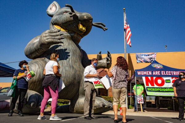 Opponents of Proposition 22 protest in front of the International Brotherhood of Electrical Workers Local 411 building in Orange, Calif., on Oct. 16, 2020. (John Fredricks/The Epoch Times)