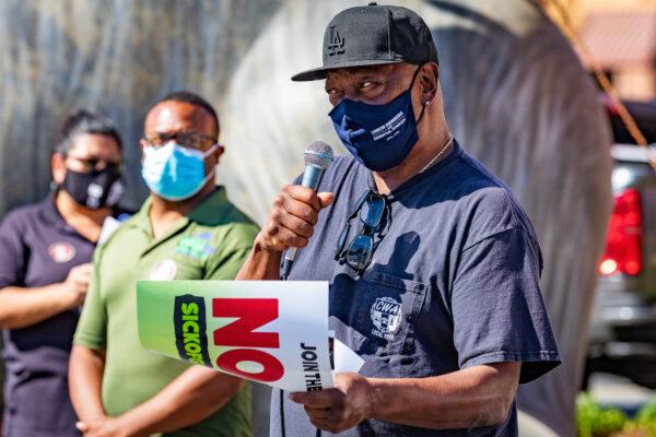 A speaker addresses the crowd at a rally opposing Proposition 22 in Orange, Calif., on Oct. 16, 2020. (John Fredricks/The Epoch Times)