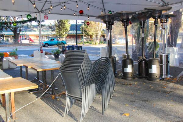 Chairs are stacked and heat lamps are gathered to be put away at Luna Mexican Kitchen in San Jose, Calif., on Dec. 7, 2020. (David Lam/The Epoch Times)