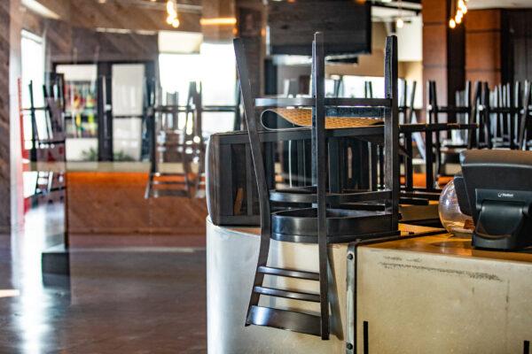 Stacked chairs line a restaurant in Costa Mesa, Calif., on Dec. 9, 2020. (John Fredricks/The Epoch Times)