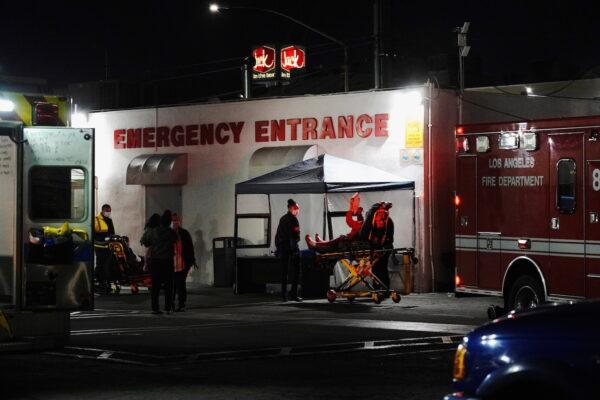 Healthcare workers treat patients outside the emergency room at the Community Hospital of Huntington Park in Huntington Park, California, on Dec. 29, 2020. (Bing Guan/Reuters)