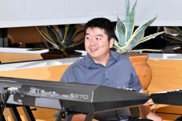 Musician and composer Tony Chen performs at "The Art of Zhen Shan Ren" exhibit in Fullerton, Calif., on Feb. 25, 2021. (William Kidston)
