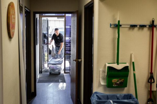 Charity On Wheels Managing Director Zach Southall loads an SUV with food, clothing, and items for the local homeless population in Anaheim, Calif., on March 5, 2021. (John Fredricks/The Epoch Times)