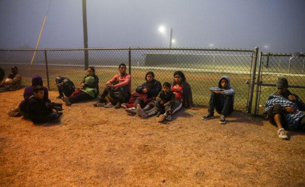 A group of illegal immigrants wait for Border Patrol after crossing the U.S.-Mexico border in La Joya, Texas, on April 10, 2021. (Charlotte Cuthbertson/The Epoch Times)