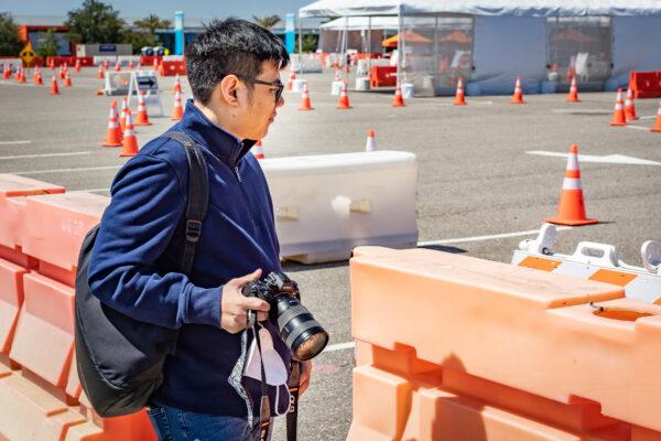 Photographer John Uy angles for the best shot in Irvine, Calif., on May 7, 2021. (John Fredricks/The Epoch Times)