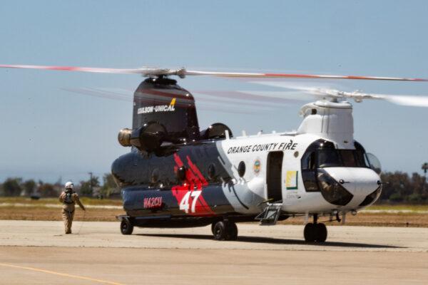 Orange County Fire Authority and partners Ventura and Los Angeles County fire departments gather for the release of a new Cu-47 Helitanker twin rotor helicopter capable of releasing 3,000 gallons of fire retardant upon wildfires. Los Alamitos, Calif., on June 14, 2021. (John Fredricks/The Epoch Times)