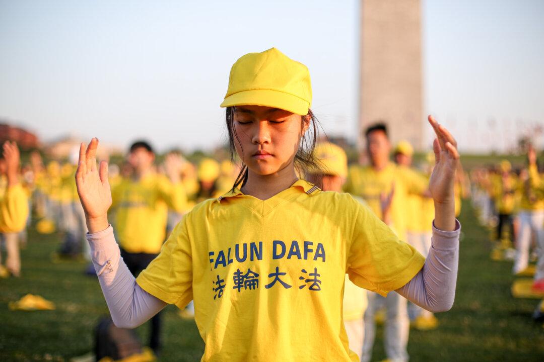 Falun Gong practitioners do exercises at an event marking the 22nd anniversary of the start of the Chinese regime’s persecution campaign against Falun Gong, in Washington on July 16, 2021. (Samira Bouaou/The Epoch Times)