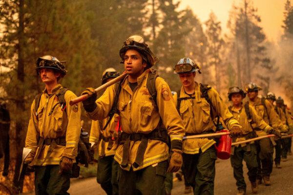 Cal Fire firefighters battle the Dixie Fire near Prattville in Plumas County, Calif., on July 23, 2021. (Noah Berger/AP)
