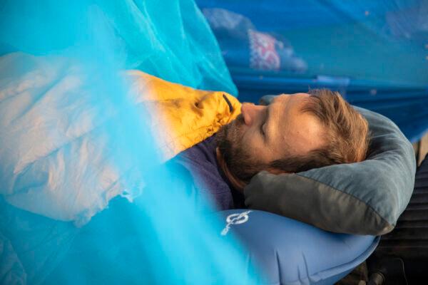 Water Wells for Africa volunteer Chris Treegarthen rests off a stomach sickness at the Water Wells for Africa basecamp area in Malawi's Machinga District on July 5, 2021. (John Fredricks/The Epoch Times)