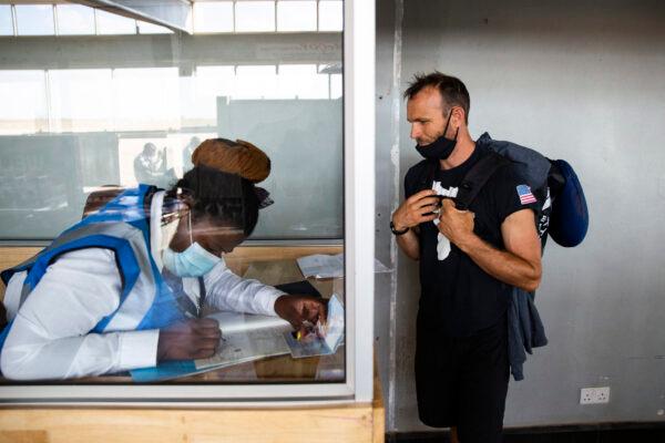 Water Wells for Africa volunteer Chris Treegarthen talks with a Malawian customs official in the City of Blantyre upon his arrival on June 26, 2021.(John Fredricks/The Epoch Times)