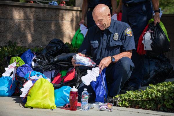 Orange County Fire Authority firefighters receive gift bags that will be taken to OCFA members fighting statewide fires in Irvine, Calif., on Aug. 26, 2021. (John Fredricks/The Epoch Times)